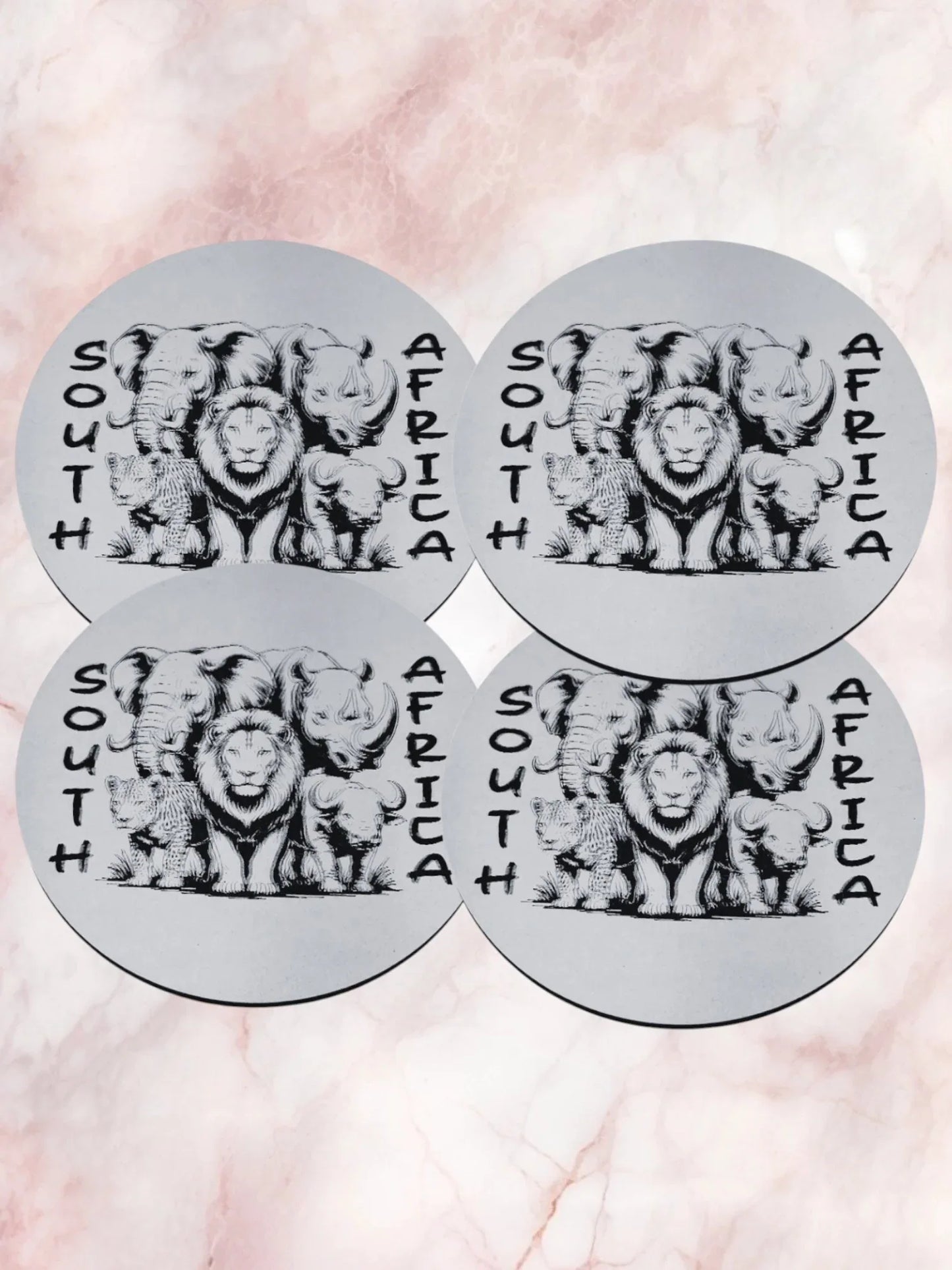 Four circular stickers with lion illustrations and 'South Africa' text on a pink marble background.