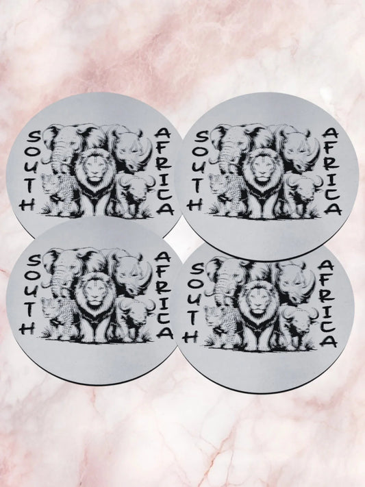 Four circular stickers with lion illustrations and 'South Africa' text on a pink marble background.