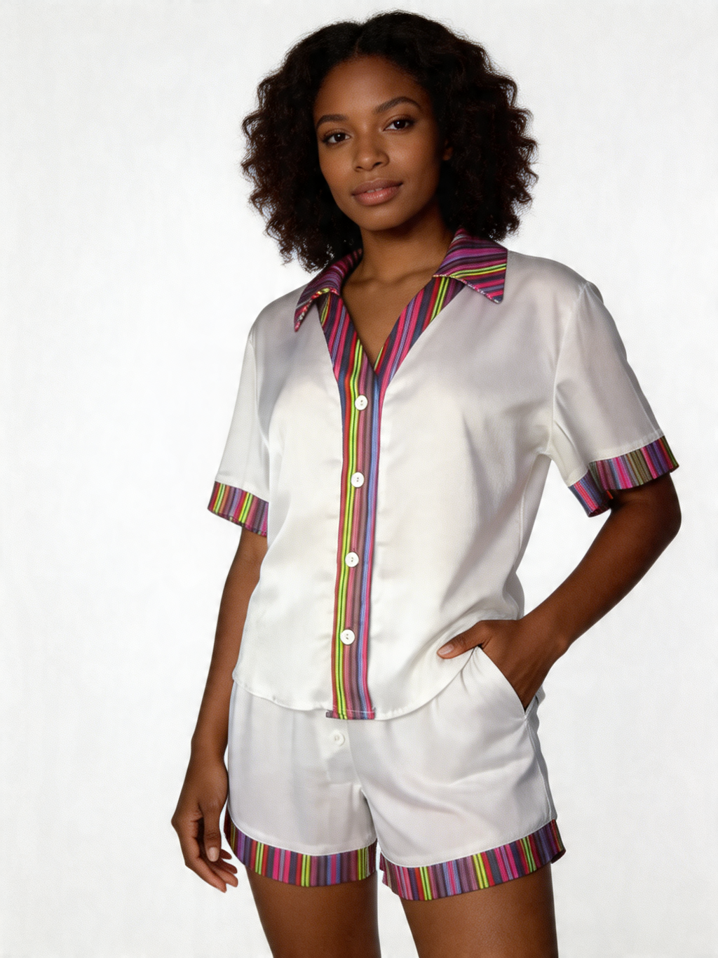 Woman wearing a white outfit with colorful trim on a white background