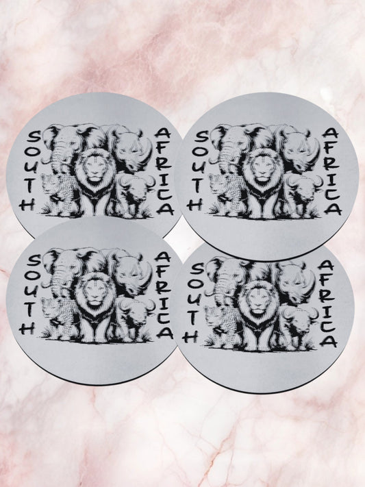Four circular stickers with lion illustrations and 'South Africa' text on a pink marble background.