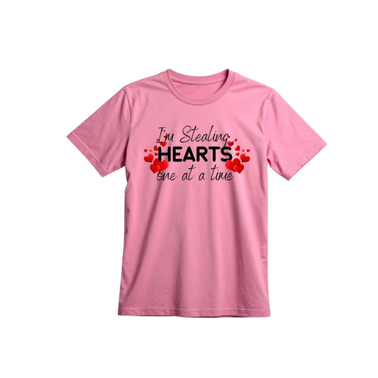 Pink t-shirt with text 'I'm Stealing Hearts one at a time' on a white background