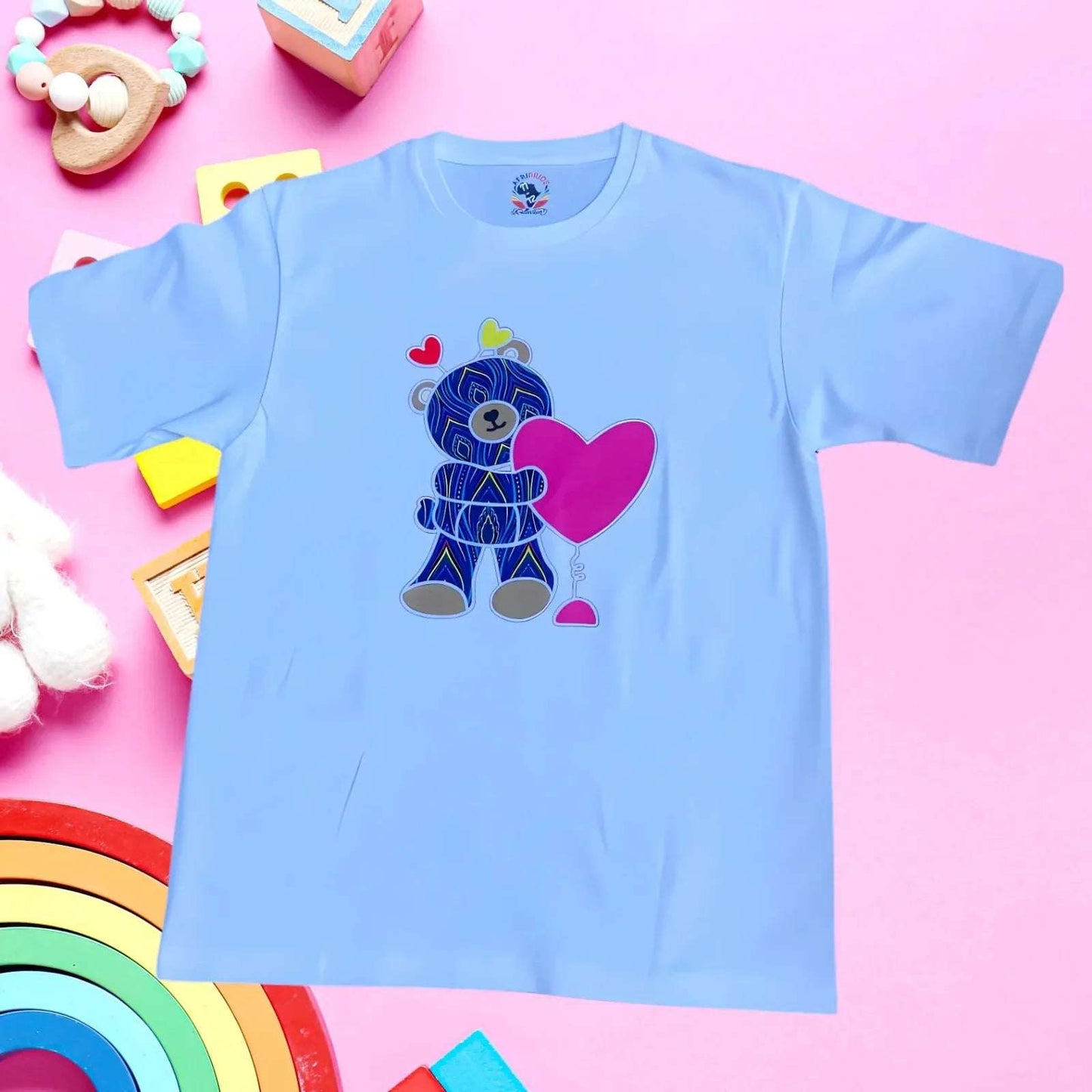 Light blue kids T-shirt featuring a TeddyBear with pink heart in African print. Crafted from soft 100% cotton for everyday wear.