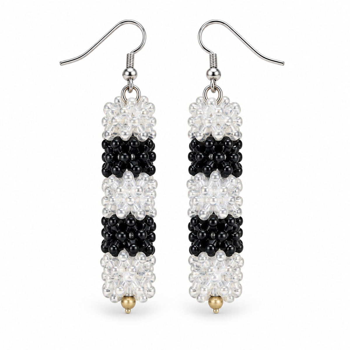 Long Black & Clear plastic snowflake bead earrings on white background