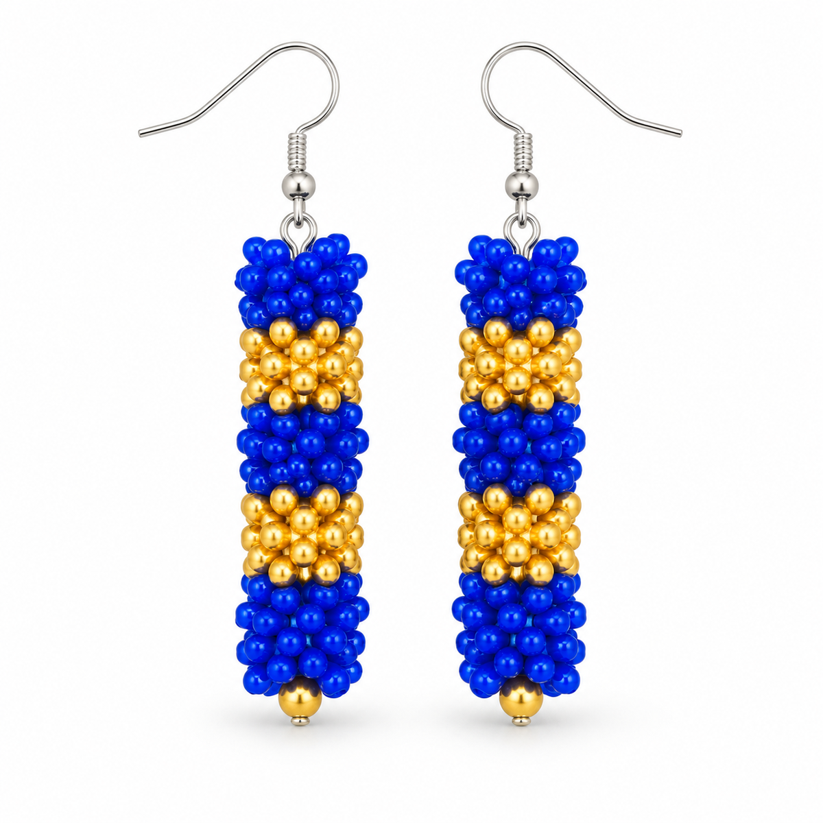 Long Blue & Gold plastic snowflake bead earrings on white background