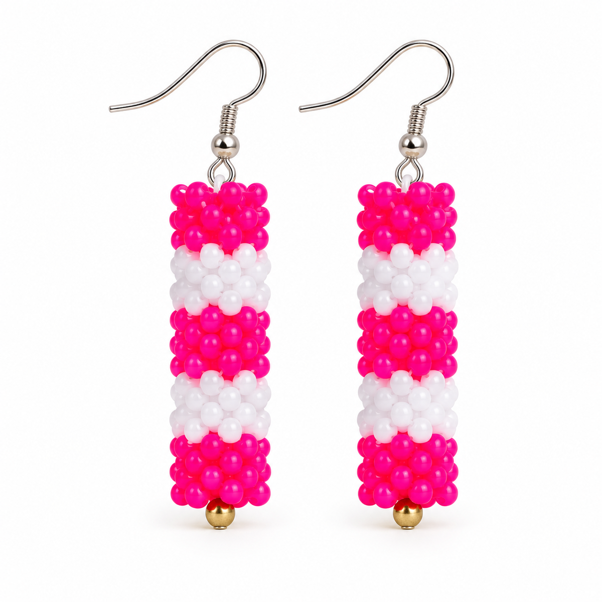 Long Pink & White plastic snowflake bead earrings on white background